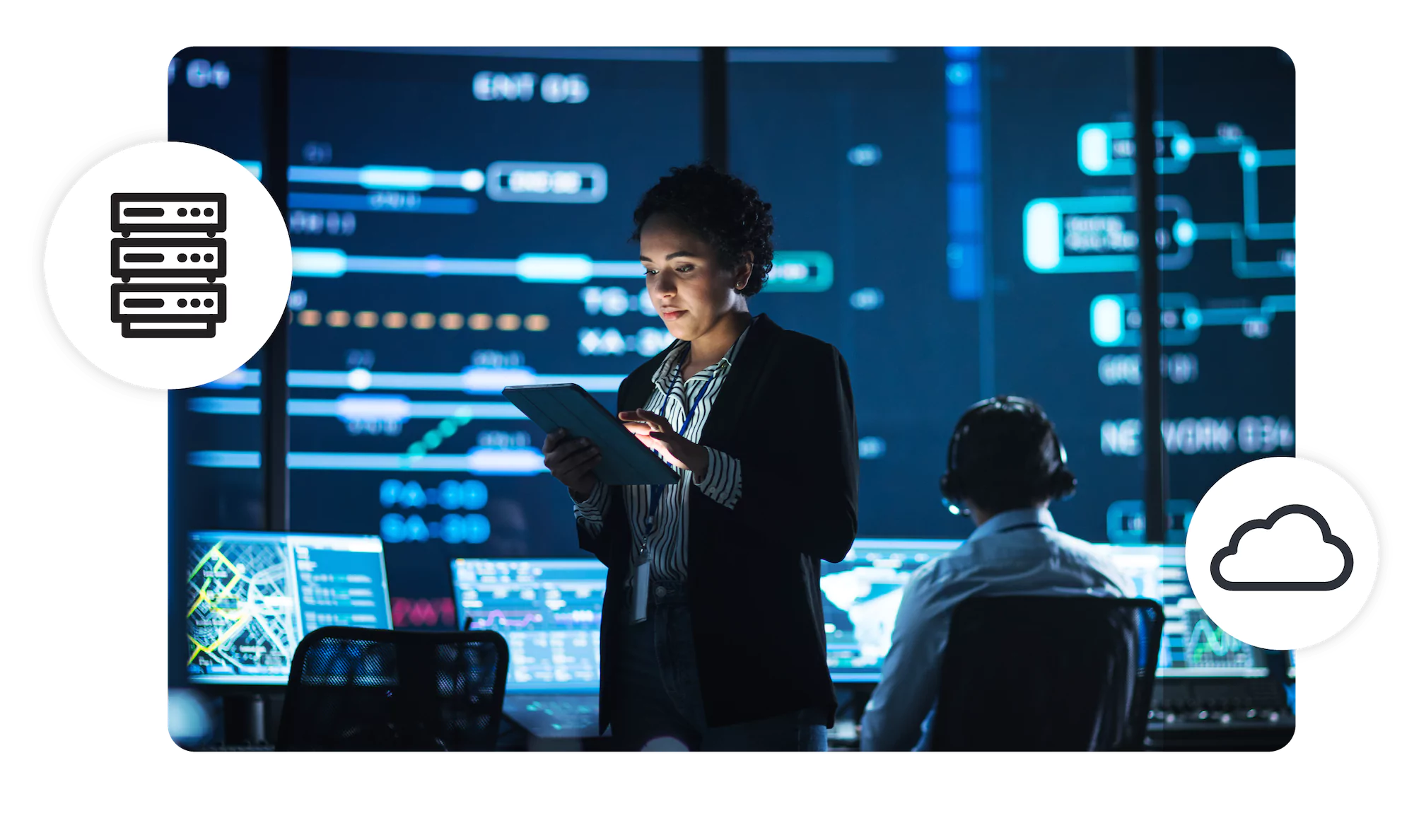 Woman stands in a command center, looking at a tablet